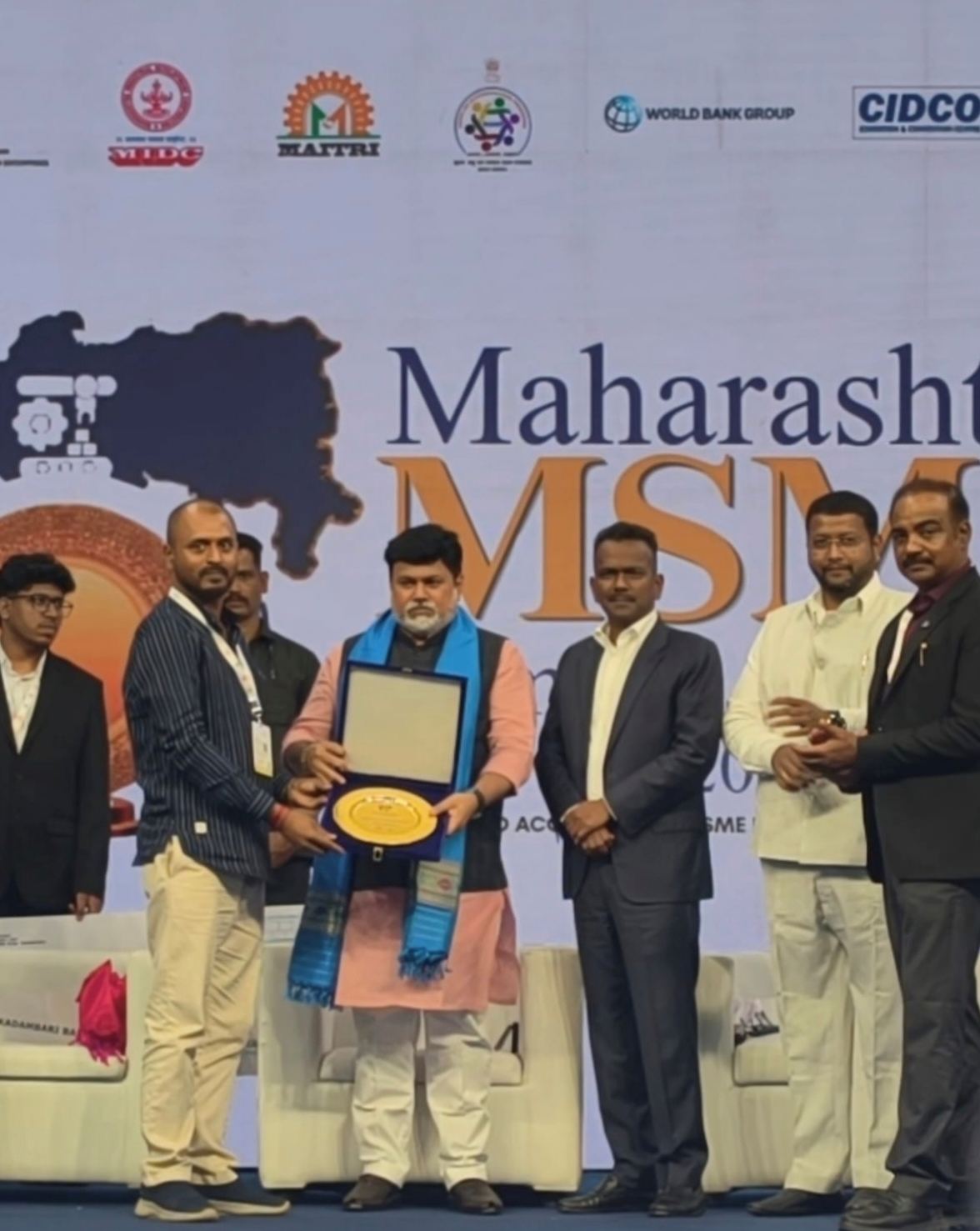 Veera Art Village receiving the Maharashtra MSME Award plaque